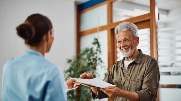 man looking at insurance paperwork